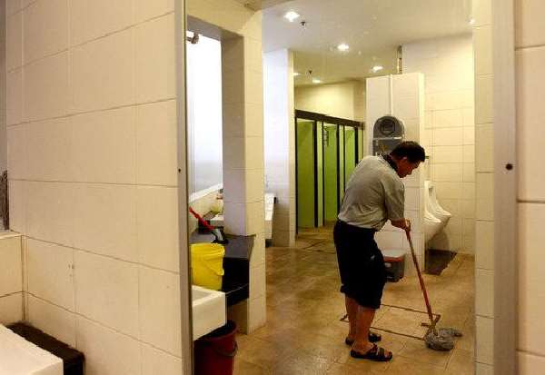 Sweeper held for keeping cell phone in recording mode in women's toilet at Taloja