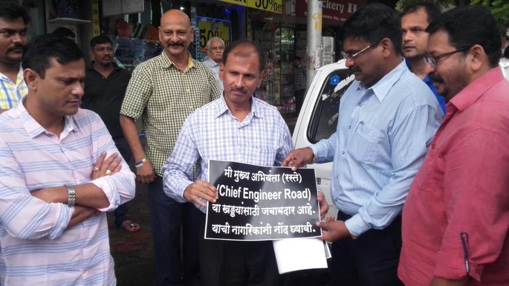 MNS shames BMC engineer, forces him to hold placard stating he’s responsible for potholes