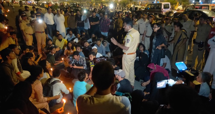 Police detain protestors during candlelight vigil at Marine Drive